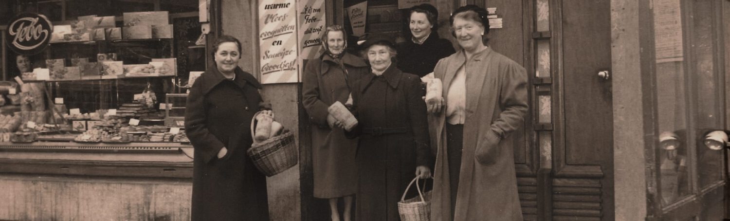 Vier vrouwen lachend voor een historische FEBO-winkel